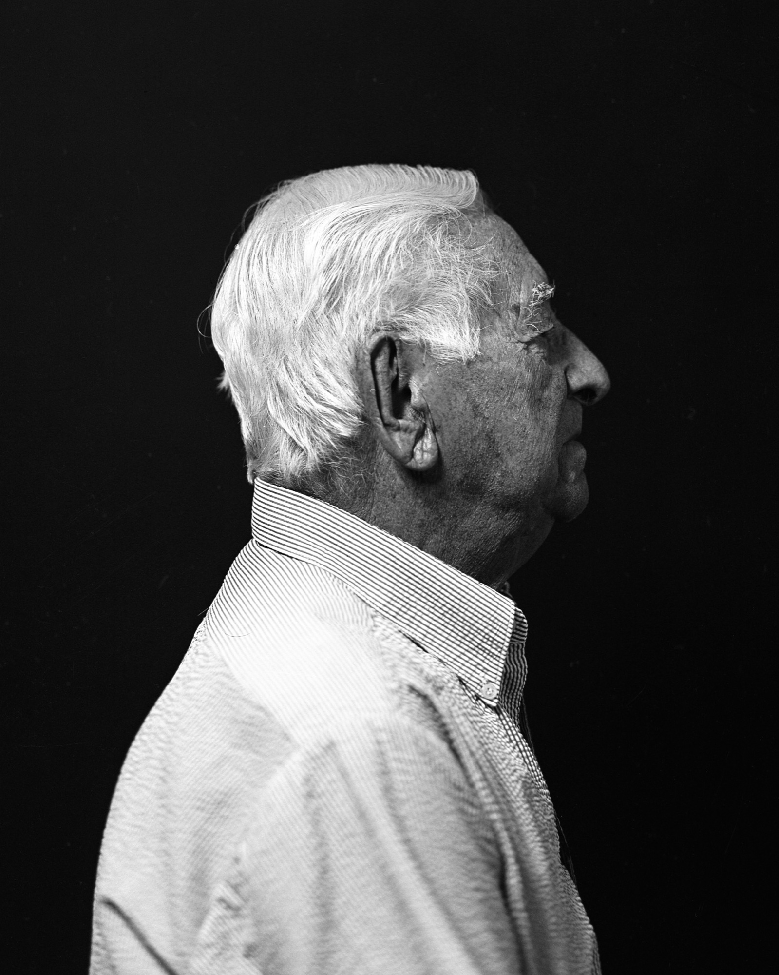 Black-and-white profile portrait of an elderly man.